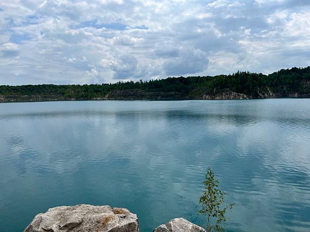 istock Scenic lake with calm turquoise water reflecting sky and clouds 2232029344
