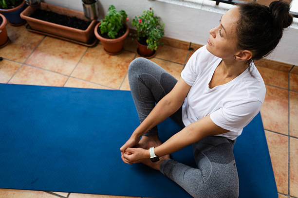 istock Woman Relaxing During Yoga Practice on a Blue Mat Indoors 2232030210