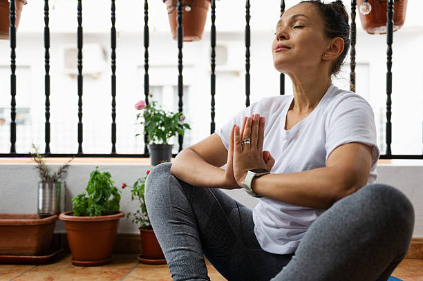 istock Mature Woman Practicing Yoga Outdoors in Relaxing Meditation Pose 2232030217