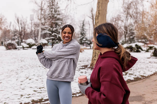 istock Women friends warming up before jogging on chilly day 2232034257