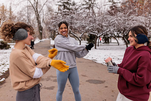 istock Women friends warming up before jogging on chilly day 2232034325