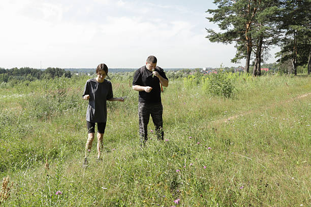 istock Scenic countryside walk with parent and child, surrounded by tall grass and distant forest, peaceful retreat from city life, outdoor mindfulness, father-daughter hiking experience. 2232040626