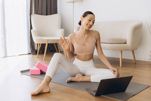 istock Yoga teacher greeting students during online class at home 2232040816