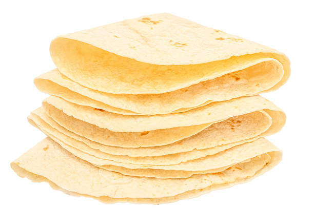 Stack of folded flour tortillas isolated on white background.