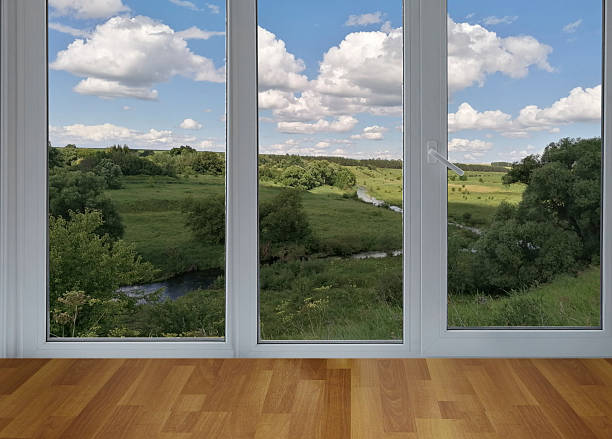 istock View from the window on the garden green trees and river and fields. 2232047437