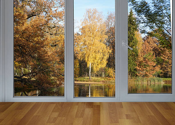 istock View from the window on the garden yellow trees. 2232047461