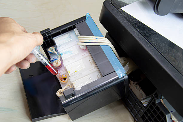 istock Top view of printer filling with yellow ink. 2232054484