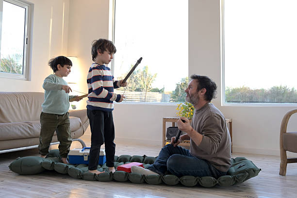 istock dad and his sons playing sailors with a mat 2232056425