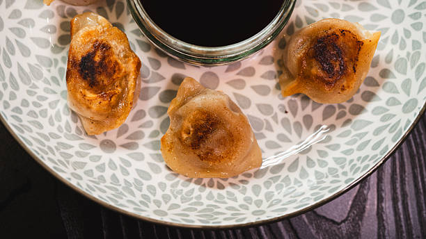 istock Crispy Pan-Fried Dumpling (Gyoza) on Elegant Plate with Soy Dipping Sauce 2232056552