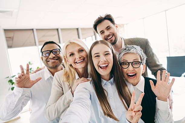 istock Happy diverse office team taking a selfie while enjoying a collaborative moment together in a bright workspace 2232058616