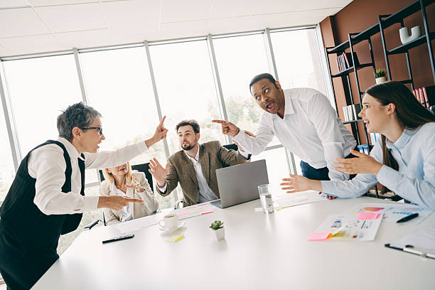 istock Office workers engaging in a lively team discussion around a meeting table in a modern workspace 2232058756