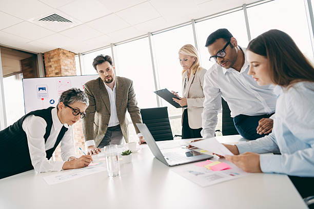 istock Group of professionals collaborating on a project in a modern office environment, engaging in teamwork and brainstorming 2232058816