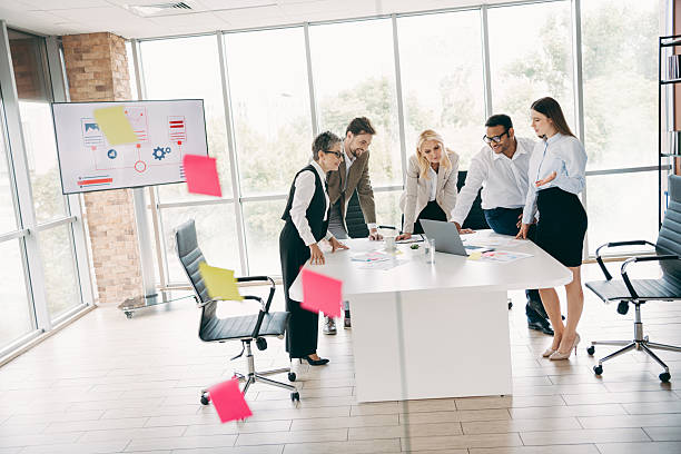 istock Team collaboration in a modern office environment during a meeting discussing project with laptop and presentations 2232058817
