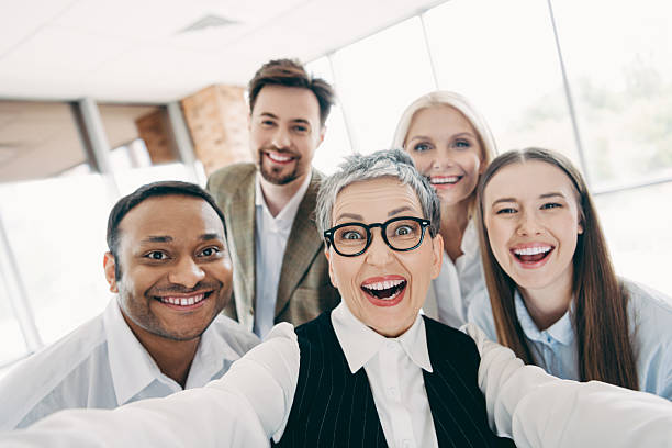 istock Group of diverse colleagues joyfully taking a selfie in an office setting during a team-building event 2232058857