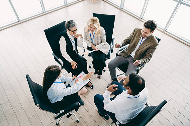 istock Group of office coworkers engaged in a dynamic brainstorming session in a modern workspace environment 2232058870