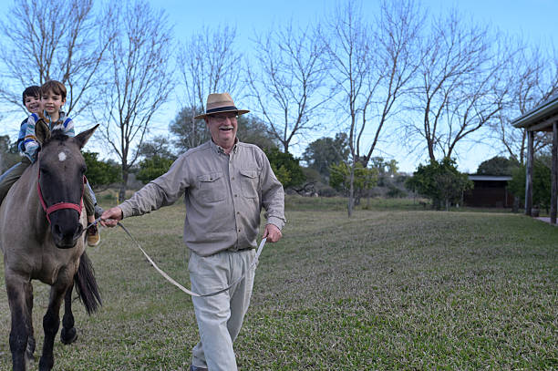 grandfather taking his nephews for a ride on horseback in the countryside