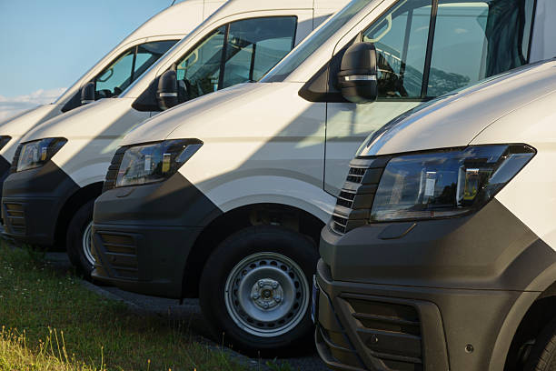 istock Fleet of White Delivery Vans Parked in Evening Sunlight 2232060845
