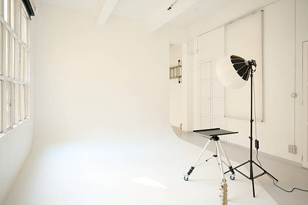 istock Empty photo studio with white background and lighting equipment ready for shooting 2232063226
