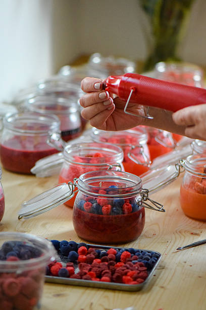 istock Handmade soy candles making process with wax berries decoration 2232065722