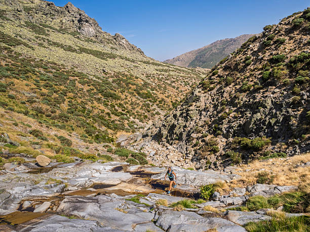 istock Hiker in summer climbing along a mountain stream. Bollo Stream. Gredos Mountains. 2232067815
