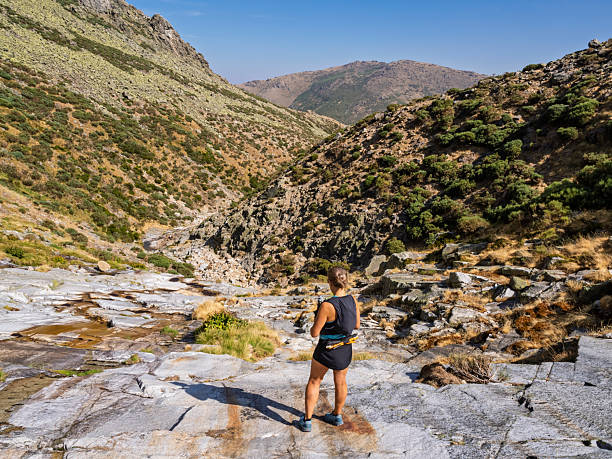 istock Hiker in summer climbing along a mountain stream. Bollo Stream. Gredos Mountains. 2232067832