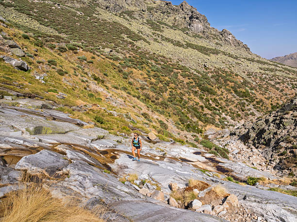 istock Hiker in summer climbing along a mountain stream. Bollo Stream. Gredos Mountains. 2232067834