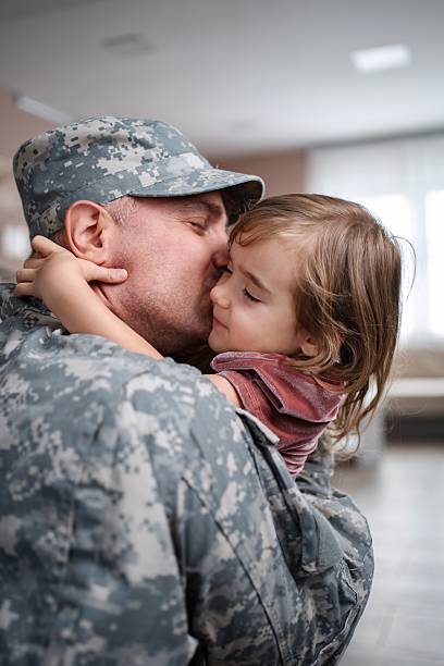 istock Soldier father kissing his daughter goodbye before deployment 2232070453