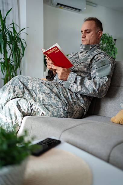 istock Soldier relaxing on sofa reading a book about Moravia 2232070519