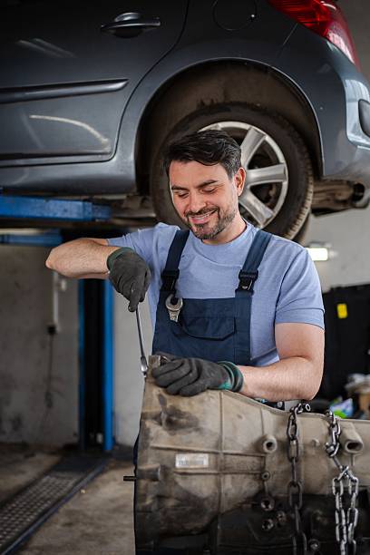 istock Mechanic repairing a car gearbox in a workshop 2232071004