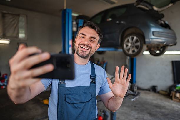 istock Car mechanic having a video call in a workshop 2232071260