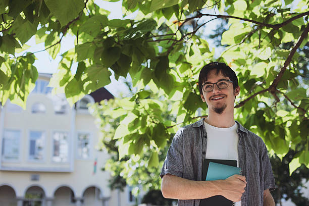 istock Young man enjoying summer day near university building 2232073063