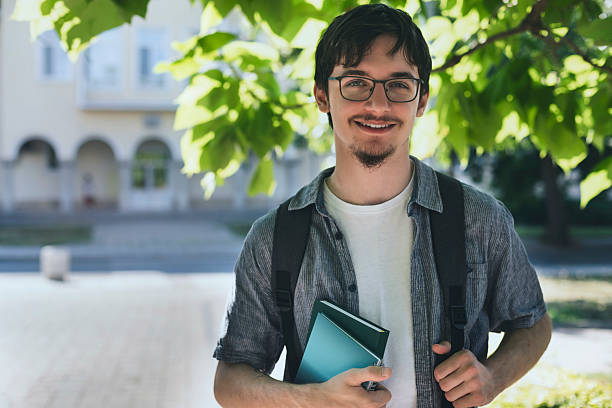 istock University student holding notebook outdoors 2232073085