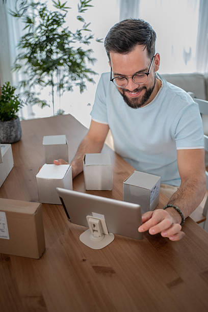 istock Small business owner managing online orders using digital tablet 2232074808