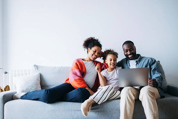 istock Happy Family Enjoying Laptop Entertainment on a Comfortable Sofa 2232076010