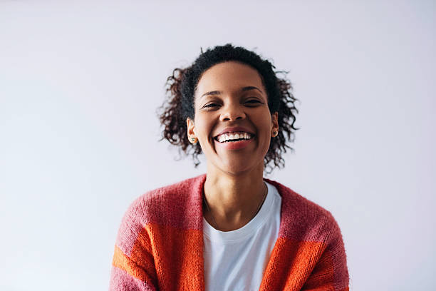 istock Smiling Woman Wearing Cozy Sweater Against Bright Background 2232076019