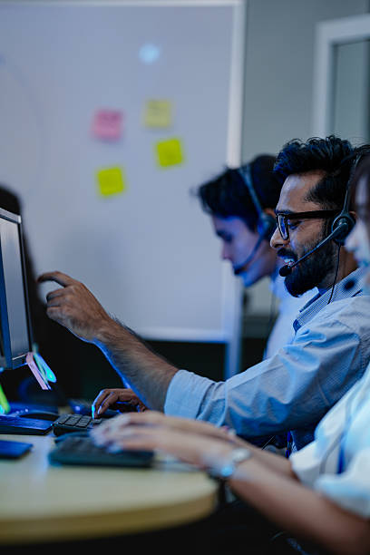 istock A diverse team of customer service representatives working a late shift in a modern call center. Focused operators with headsets provide all day technical support to clients. 2232077039
