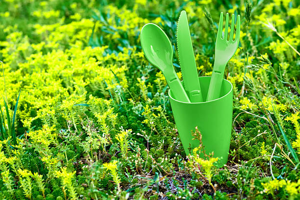 istock Green and yellow picnic.Plastic dinnerware set.Cup,fork,knife,spoon 2232077153