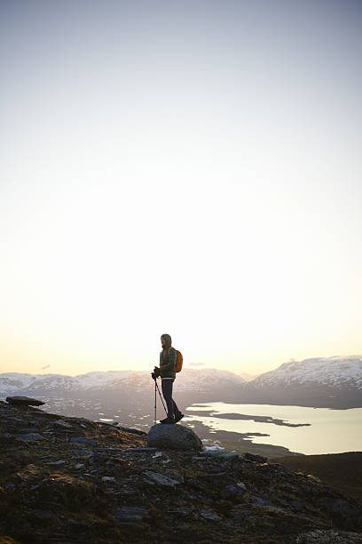 istock Young man stands on hill above lake at midnight 2232077870