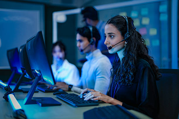 istock A diverse team of professionals works at a customer support call center. A female operator in a headset assists a client, providing excellent 24/7 technical or sales service. 2232077924