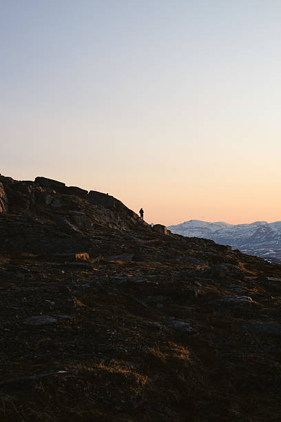 istock Young man on mountain ridge at midnight 2232077943