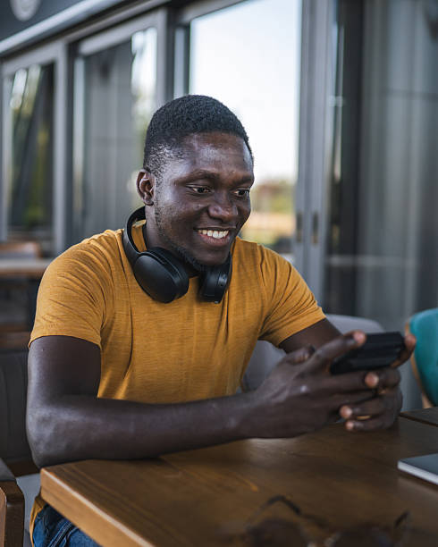 istock Freelancer enjoying smart phone during work break at outdoor cafe 2232079138
