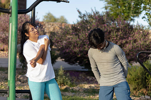 istock Young people stretching at outdoor gym in park 2232083040