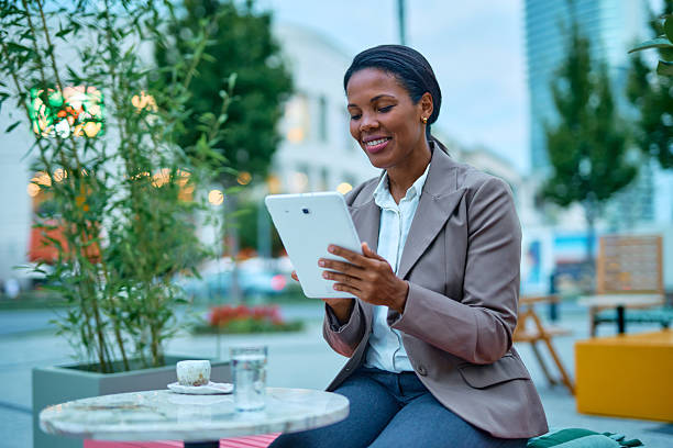 istock Businesswoman using digital tablet while sitting at outdoor cafe 2232086861