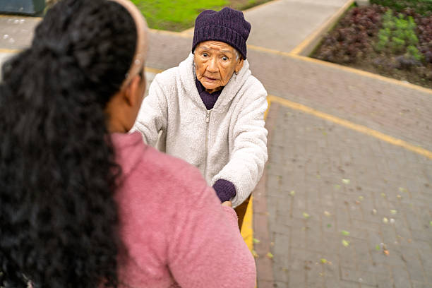 istock Nurse assisting elderly woman on a walk in the park 2232087270