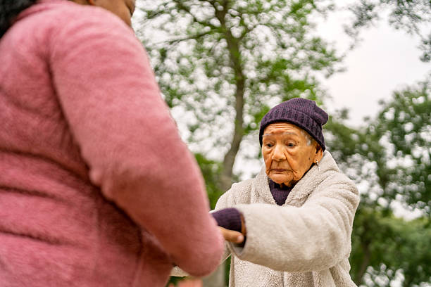 istock Nurse assisting elderly woman while walking in park 2232087285