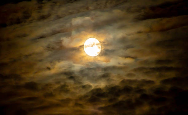 istock Super full moon cloudy in dark sky on the ocean horizon at midnight 2232087315