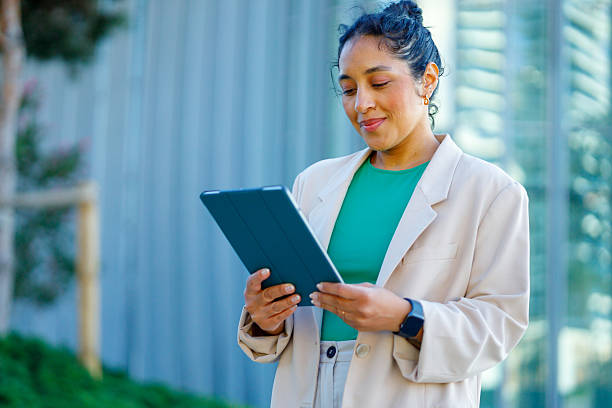 istock Smiling businesswoman working outdoors with a digital tablet, enjoying the fresh air while balancing professional and personal life 2232090120