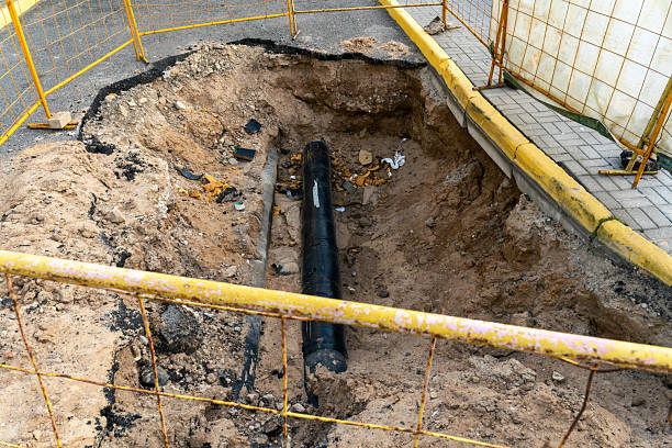 istock Construction Site Excavation with Underground Pipe Installation. Urban Road Repair Project Showing Open Excavation and New Water Pipeline Installation Preparing for Infrastructure Upgrade. 2232094360