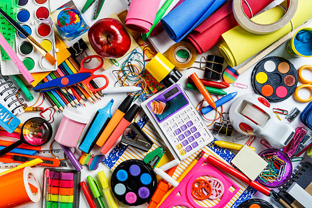 Top view of office supplies on white background.