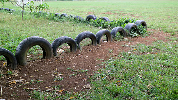 Half Buried Tires in Grassy Field